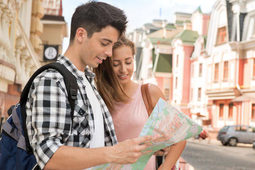 A traveling couple looks at a map