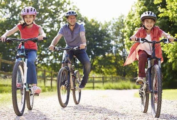 A man and his two children biking outdoor