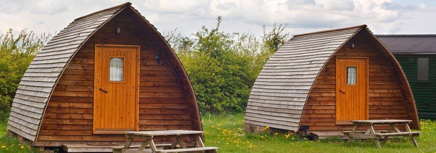 Two glamping tents with benches outside