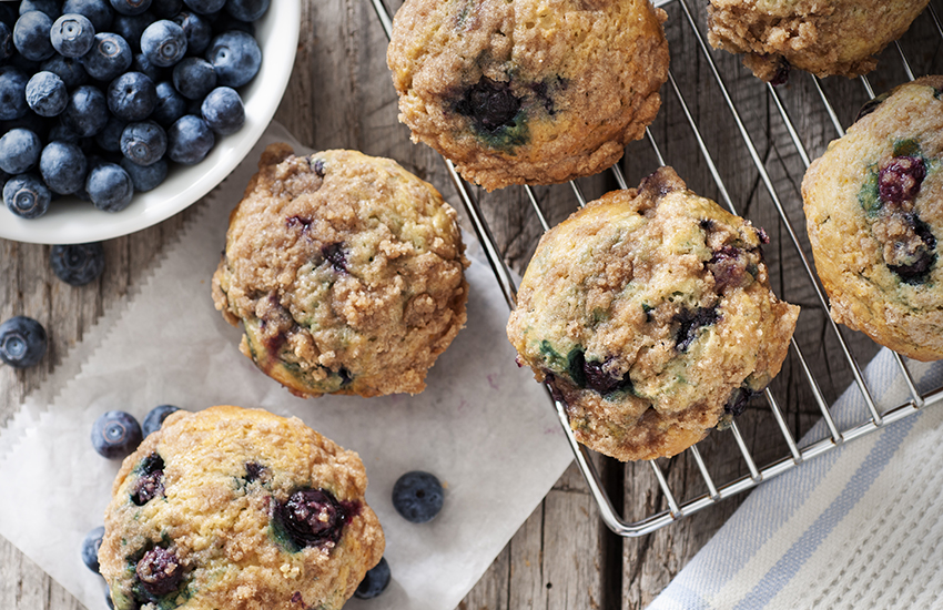 Blueberry muffins with berries and cooling rack