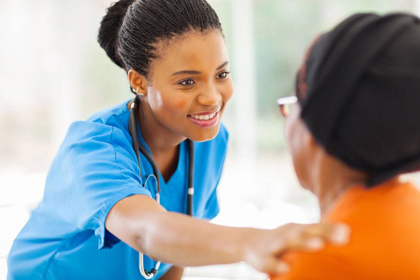 A nurse assisting her patient