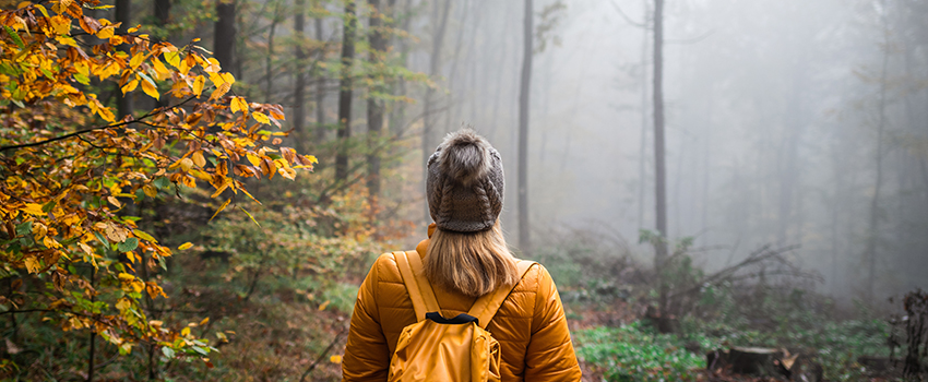 Woman in woods in fall