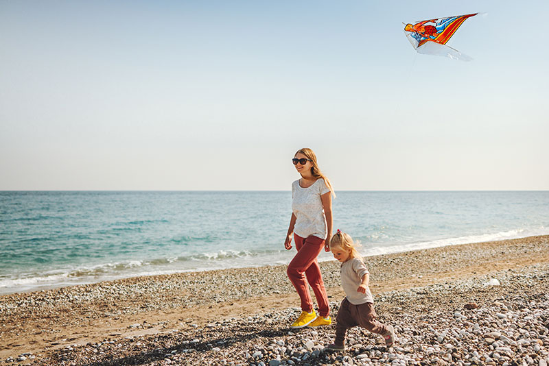 Woman and her daughter on the beach