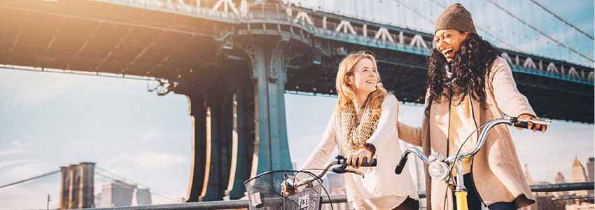 Two friends on bikes in New York