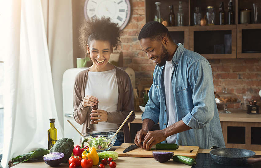 A black couple cooking together