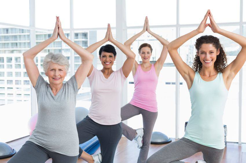 A group of women doing the same yoga pose together