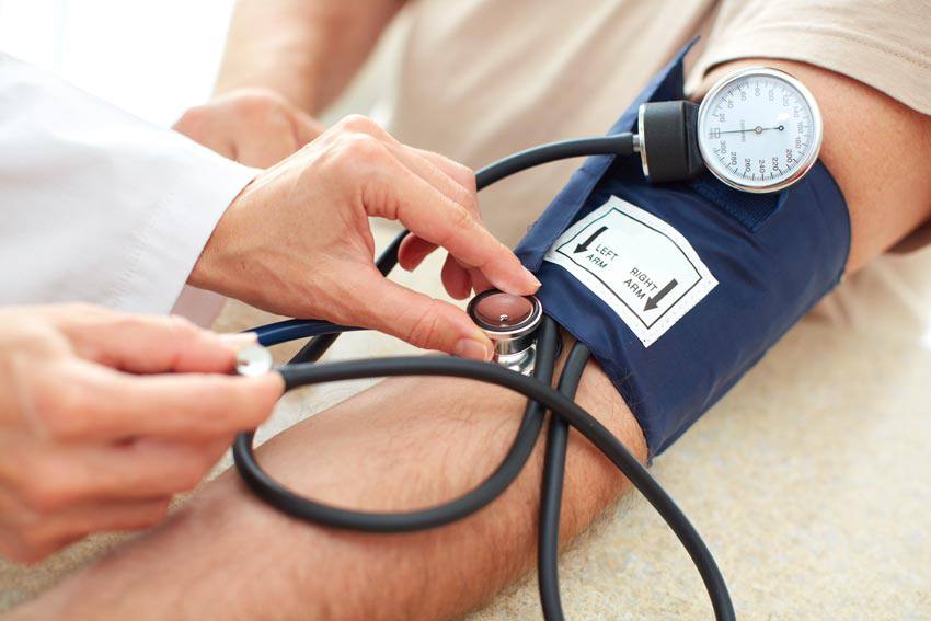 A doctor using a sphygmomanometer on a patient