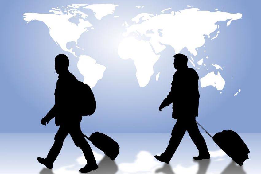 Travelers carrying their bags with a world wallpaper on the background