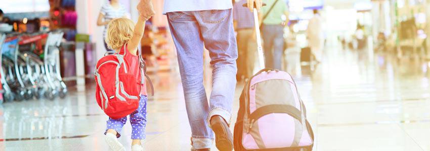 A child and their parent traveling together