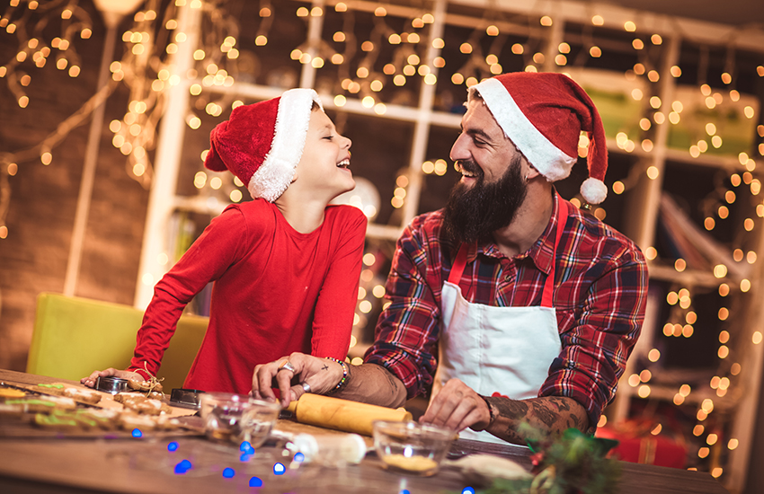 A dad and son doing christmas activities together