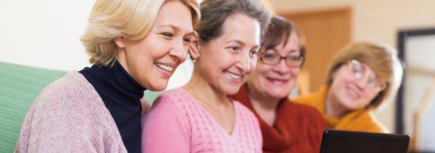 Elderly ladies in front of a computer