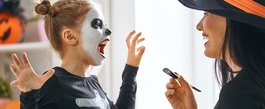 Kid dressing up for Halloween