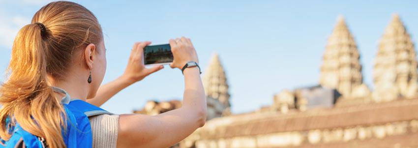 A lady takes a photo of a building