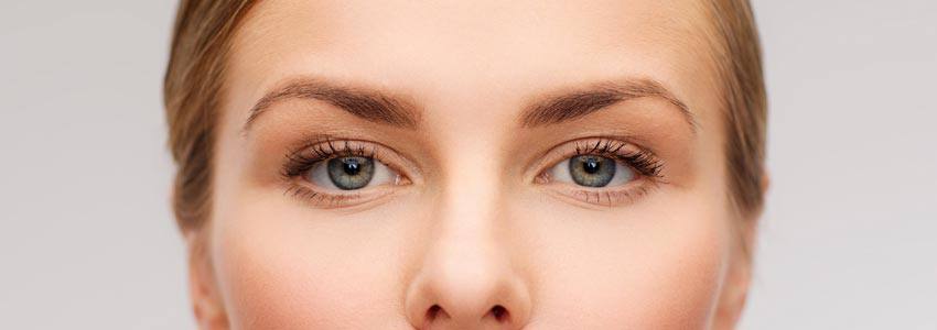 A closeup of a woman with blue eyes and blonde hair