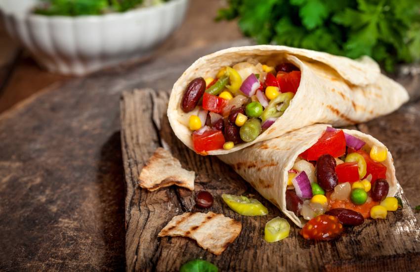 Two mexican burritos filled with veggies