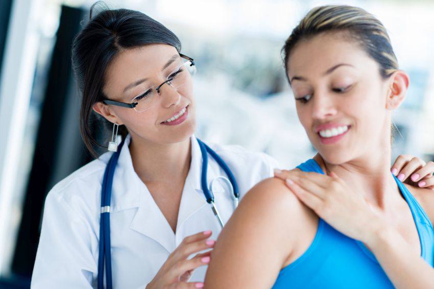 Physiotherapist examining a patient