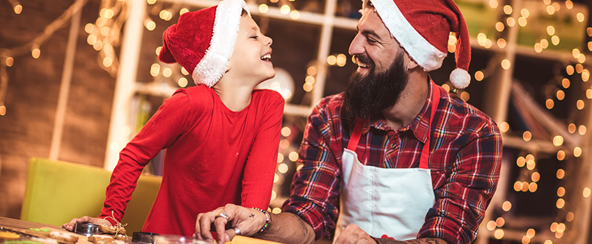 A dad and son doing christmas activities together