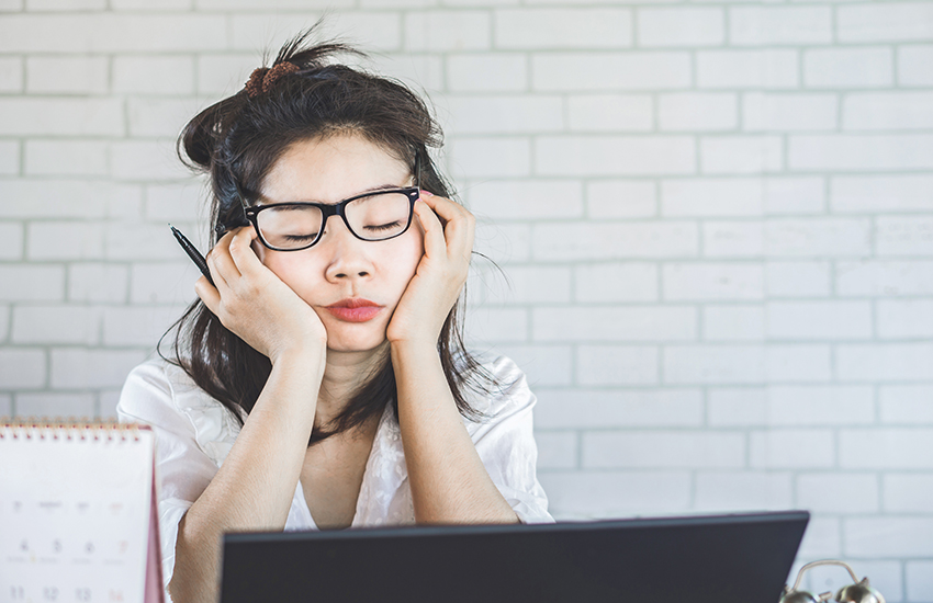 A woman on the computer falling asleep