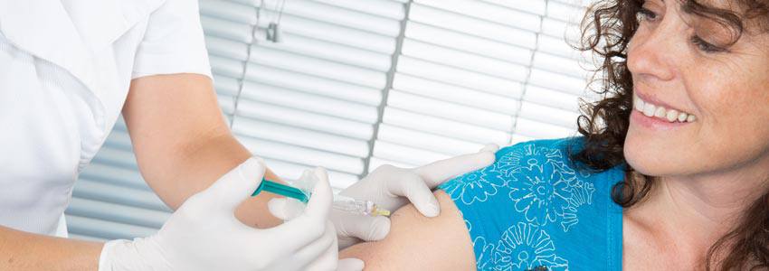 A woman getting a flu shot on her arm