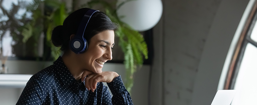 Woman smiling at computer screen