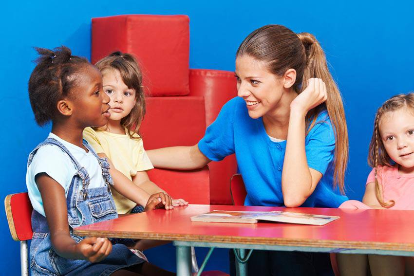 An adult talking with three different children