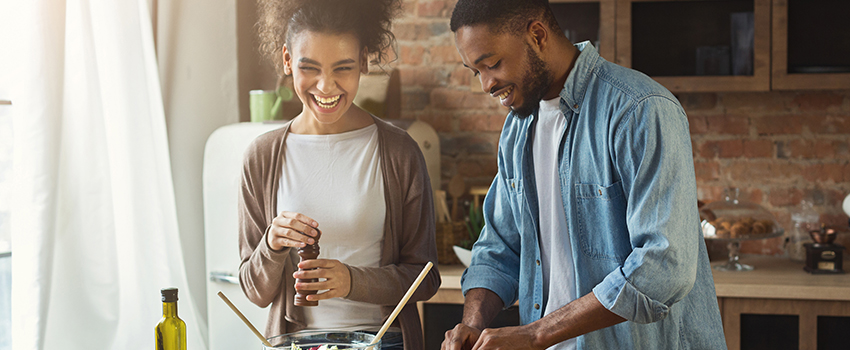 A black couple cooking together