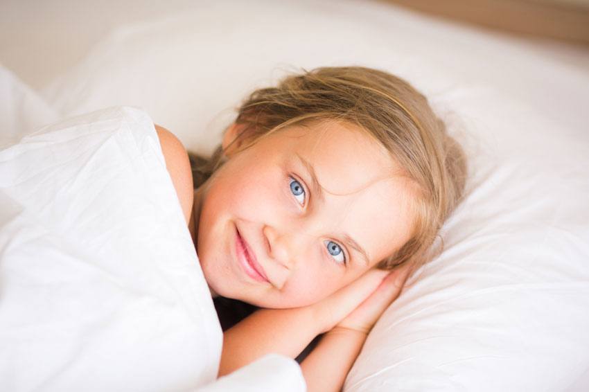 Little girl lying in bed