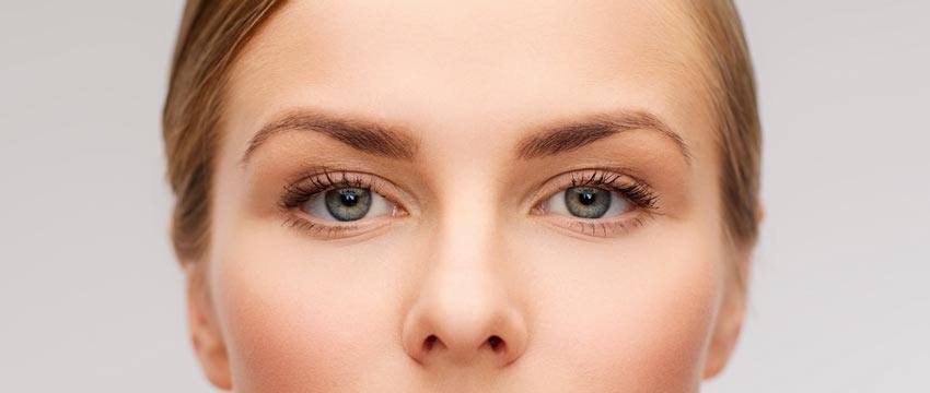 A closeup of a woman with blue eyes and blonde hair