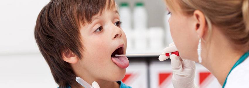 Doctor examining child's throat