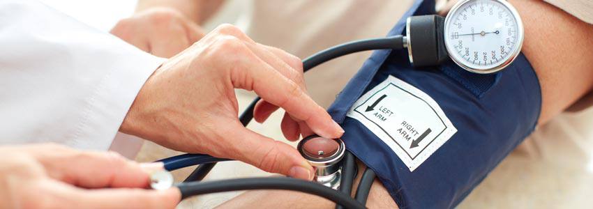 A doctor using a sphygmomanometer on a patient