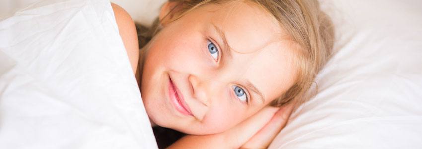 Little girl lying in bed