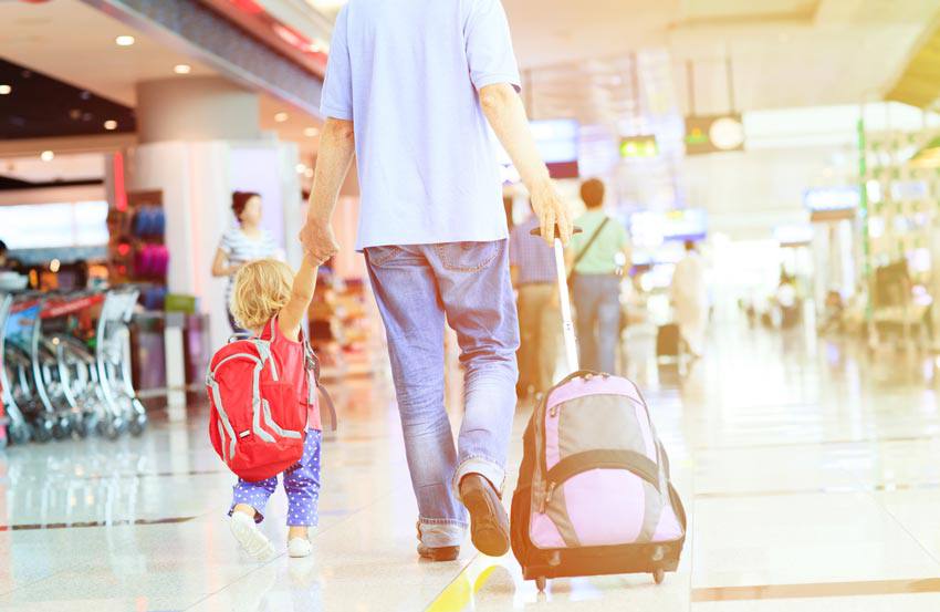 A child and their parent traveling together