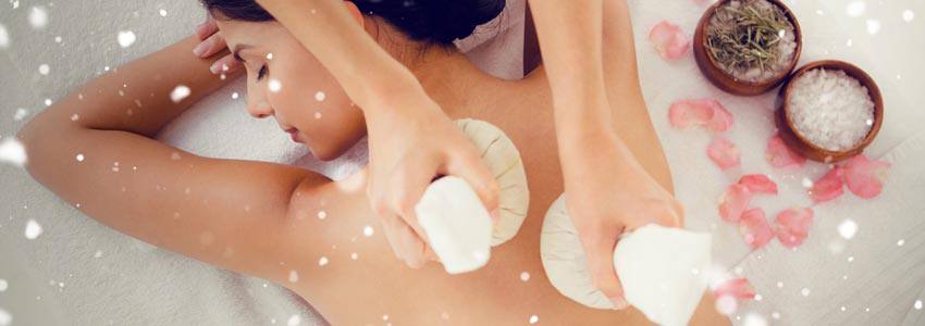 A woman getting a massage by a masseuse with an object