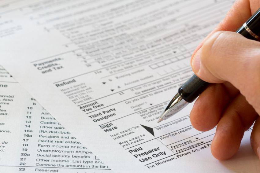 A person filling out a tax form