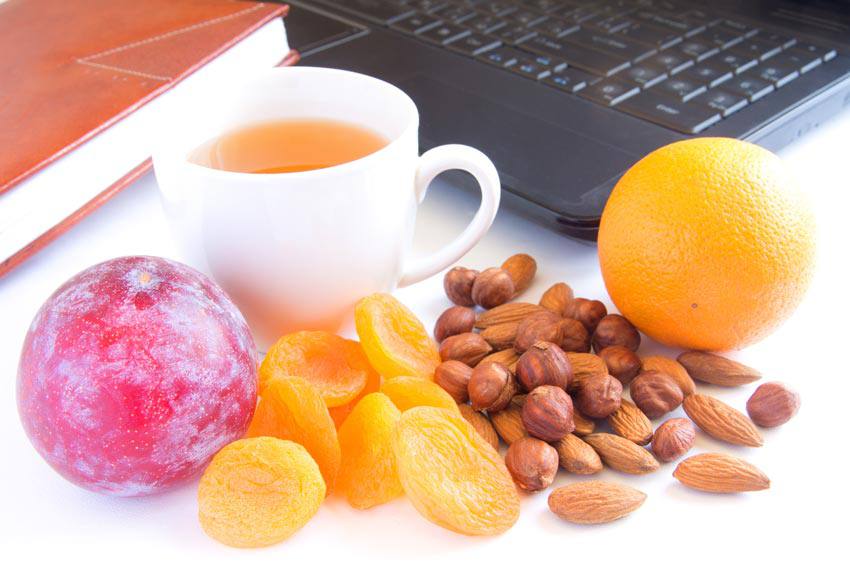 Various healthy food for health beside a computer