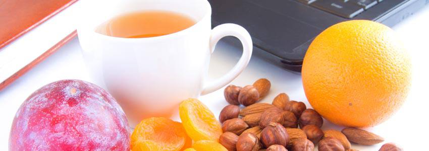 Various healthy food for health beside a computer