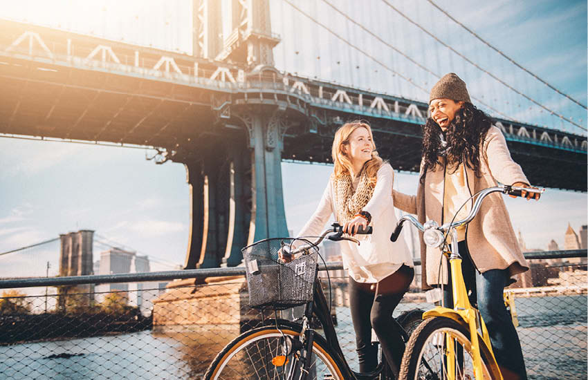 Two friends on bikes in New York