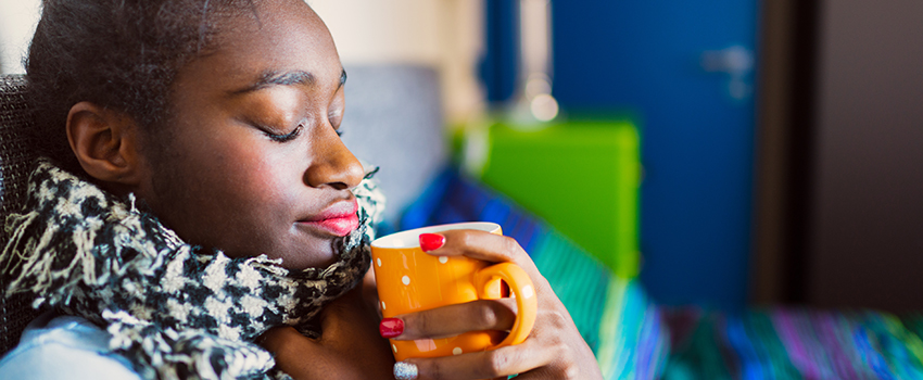 Sick woman with sore throat and tea