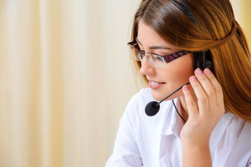 Call center representative listening to a customer on her headset