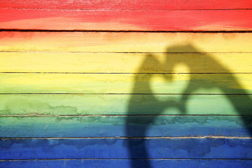 The pride flag with a shadow hand heart