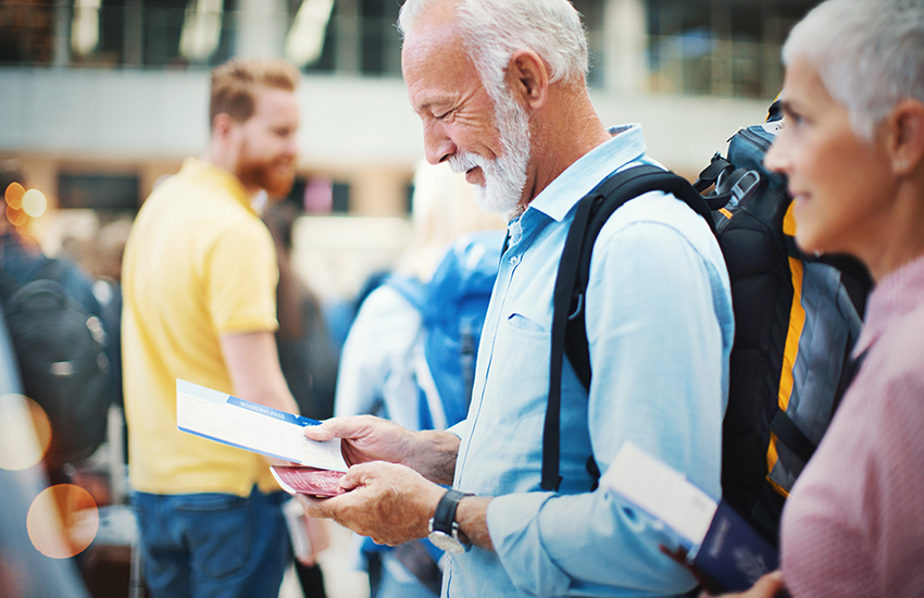 A person holding their passport and documents at the airport