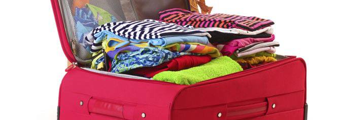 A red suitcase full of clothes