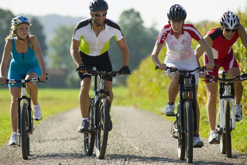 Young adults biking on a country side