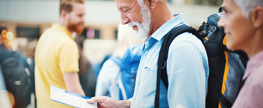 A person holding their passport and documents at the airport