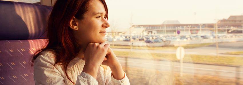 A woman looking out of a window on a train