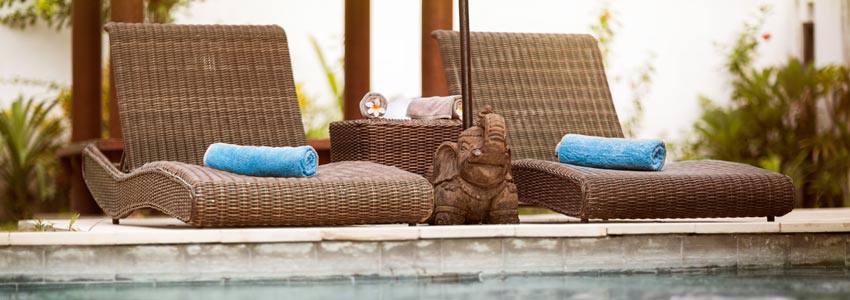 Comfortable chairs on the edge of a swimming pool