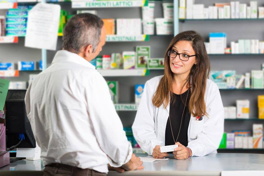 A pharmacist talking to a customer at the counter